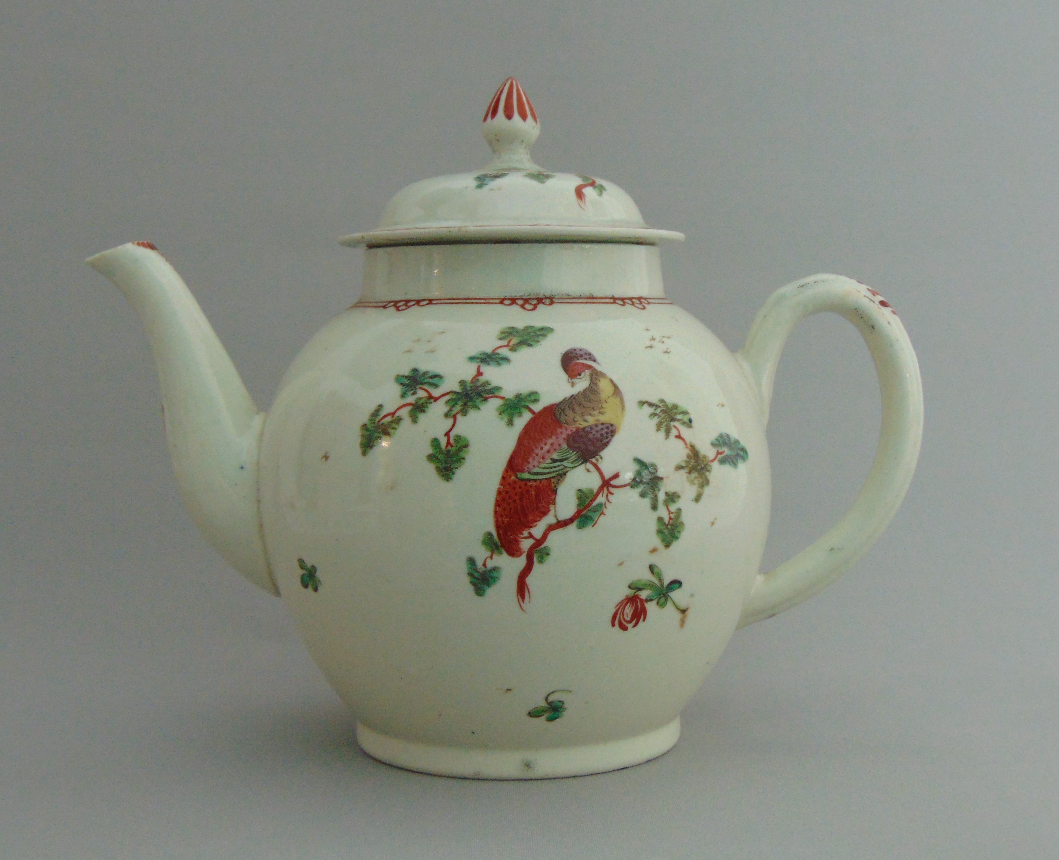 A Liverpool globular teapot and cover painted with birds in branches, circa 1775, 17.