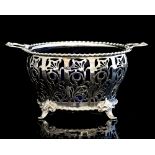 A George V silver two handled dish with blue glass liner,