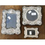 Two embossed silver photograph frames hallmarked London 1982 and Birmingham 1989 and a small plain