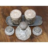 A pair of silver dressing table jars with indistinct Chester hallmarks on a silver tray,