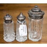 A trio of silver capped condiment bottles, comprising a mustard pot,