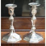 A pair of George V silver weighted candlesticks, modelled in the early 18th Century style,