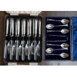 A cased set of silver teaspoons with shell bowls and part twist handles,