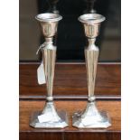 A pair of silver candlesticks,