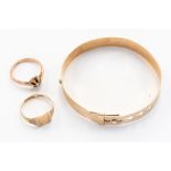 A 9 ct gold Christening bangle together with two 9 ct gold rings, one set with old cut diamond,