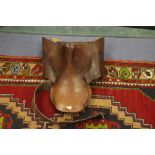 A leather saddle, having hessian lining, with leather girth, stirrups,