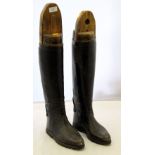 A pair of gentlemen's black leather riding boots, wooden trees,