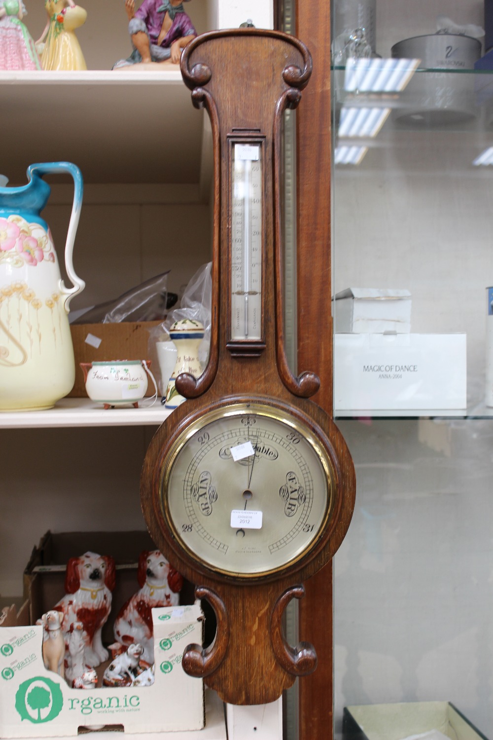 An oak wheel barometer, including thermometer, by J.F.