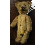 A sawdust filled mohair teddy bear, measuring approx 12 cms in length, having jointed limbs,