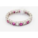 A full eternity stamped 18 ct white gold set with white and pink/red stones, ring size N,