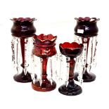 Two matched pairs of Victorian cranberry glass lustres,