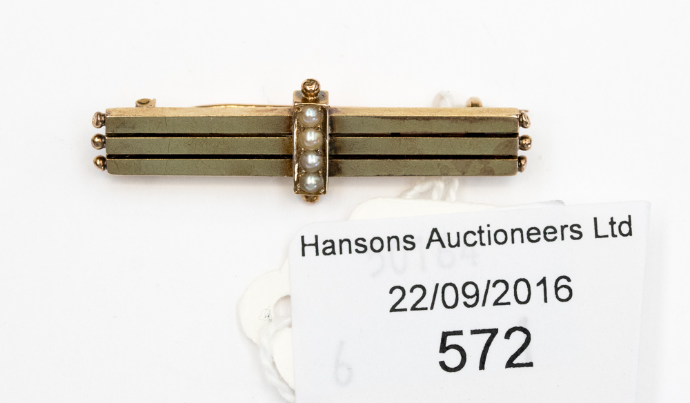 A 15 ct gold bar brooch, set with four seed pearls across three bars, weighing approx. 3.