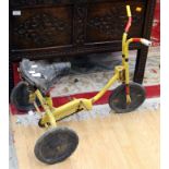A vintage children's tricycle, red and yellow painted,