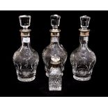 Three silver collared cut glass decanters, comprising two Birmingham 1992, and one Birmingham 1991,