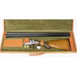 A modern cased 12 bore side by side 2 3/4" chambered hammer nitro proved shotgun fitted with