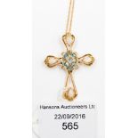 A 14 ct rose gold cruciform pendant, set with four opals and a faceted blue stone,