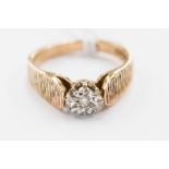 A 9 ct gold ring set with an illusion set diamond, small round brilliant cut diamonds, approx. 0.