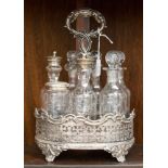 An early Victorian silver plated cruet set, the central section with a cast handle,