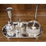 A silver on copper raised tray, cream jugs, sugar bowl,