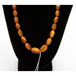 A string of butterscotch amber beads approximately 19.