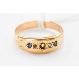 An 18 ct gold gypsy set diamond chip and sapphire ring, gross weight approx. 2.