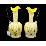 A pair of late 19th Century Bohemian yellow ground glass ewers