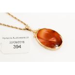 A 9 ct gold banded blue lace agate and carnelian pendant and chain,