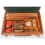 A Parker Hale 12 bore boxed cleaning kit containing a pair of snap caps, oil can,