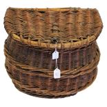 A woven willow fishing kreel with shaped wooden peg for closure,