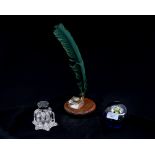 A Victorian glass inkwell and cover, with desk stand, comprising inkwell and green quill pen,