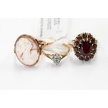 Three 9 ct gold dress rings comprising cameo, garnet cluster and small emerald,