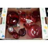 A box of cranberry glass including a silver mounted whisky flagon and a bowl within a foliate frame