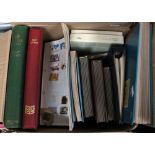 A cardboard box containing twelve albums/books of GB, IOM and worldwide mainly used stamps,