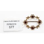 A 9 ct gold brooch set with four garnets in floral setting, approx. 34 mm, gross weight approx. 3.