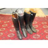 A pair of gentlemen's black leather hunting boots with metal trees and a pair of gentlemen's black