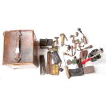 A vintage worn leather covered cartridge box containing various tools and cartridge reloading