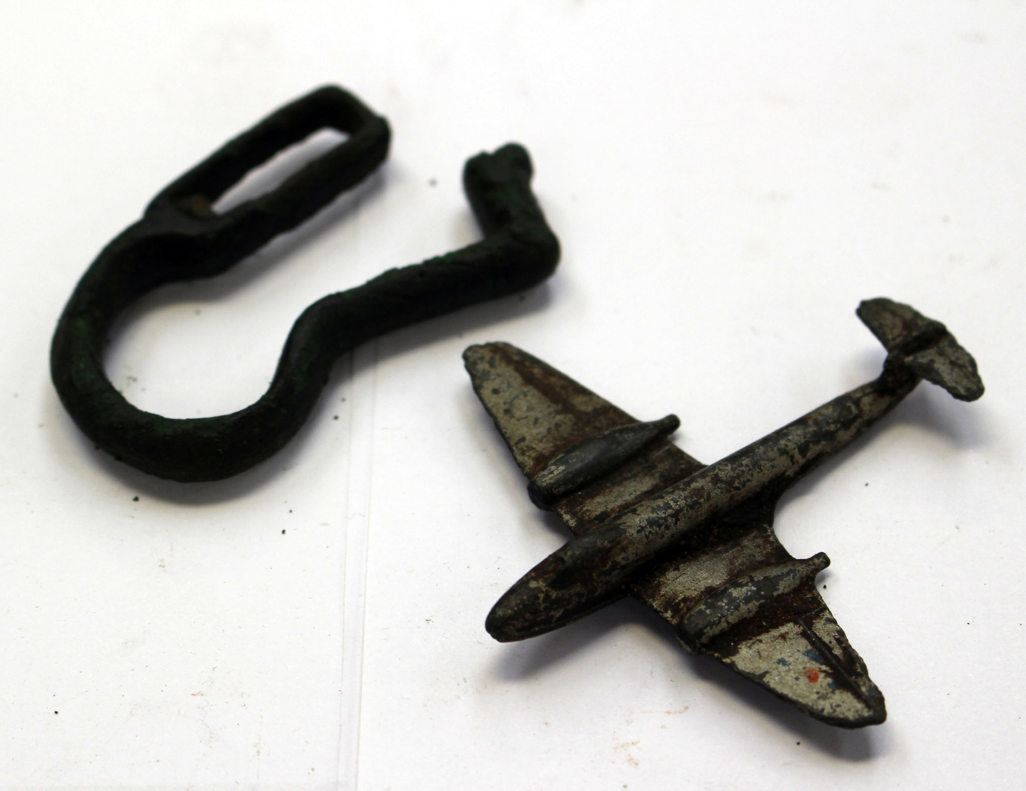 Belt hangers, 14th /15th Century, zoomorphic and a child's toy Gloster Meteor Jet aircraft, 1940s.