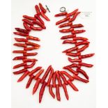 A dyed coral necklace in the form of a fringe