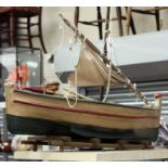 A mid 20th Century wooden model of a sailing ship on a raft,