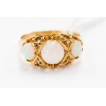 A Victorian 18 ct gold and opal three-stone ring, diamond chip spacers (one missing) 1899,