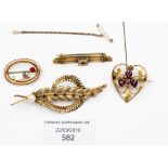 Two Victorian 9 ct gold brooches, one in the form of a heart set with seed pearls and garnets,