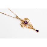 An Edwardian 15 ct gold, amethyst and split pearl pendant on a later 9 ct gold chain,