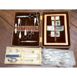 A ladies leather cased sewing set with mother of pearl handled carved button hook, cork screw,