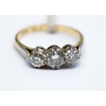 A diamond three stone 18ct yellow gold ring, platinum settings,