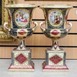 A pair of large Vienna style two handled urns with printed decoration and gilding,