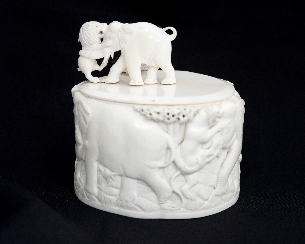 A late 19th century carved ivory box and cover,