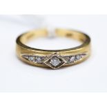 A diamond and 18ct yellow gold ring, the central modern round brilliant diamond measuring approx 0.