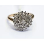 A diamond three row 9ct gold cluster ring, the diamonds approximately 0.