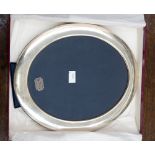 A boxed Asprey silver oval picture frame, 30 cm by 25 cm approx,