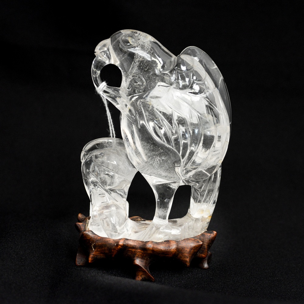 A Chinese carved rock crystal figure of an eagle, on hardwood stand, 14.